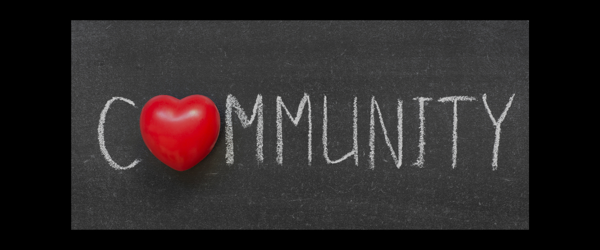 An image of the word community. The "O" is replaced with a heart. 